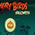 Halloween-tema med teksten Angry Birds i orange og Halloween i gult, samt en play-knap formet som et græskar mod en mørk baggrund med træer