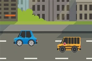 To biler kører på en vej foran bygninger og grønne buske