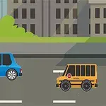 To biler kører på en vej foran bygninger og grønne buske