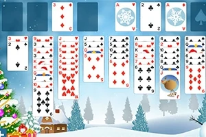 Et spil kort er lagt ud i faner, med juletema baggrund som viser snedækkede træer og et juletræ med lys
