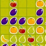 En række frugtmotiver, herunder druer, kirsebær, appelsiner, pærer, bananer og æbler, arrangeret på en grøn ternet baggrund