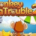 En abe sidder på en strand med en parasol foran en sø og bjerge, med bananer og titlen Monkey in Trouble 2 i baggrunden